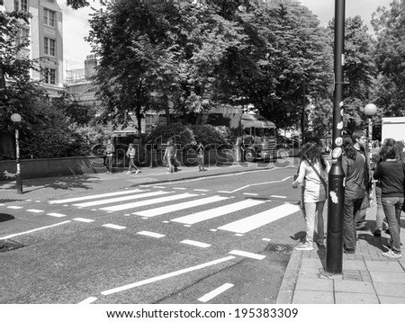 LONDON, ENGLAND, UK - JUNE 18: People crossing the Abbey Road zebra crossing made famous by the 1969 Beatles album cover on June 18, 2011 in London, England, UK
