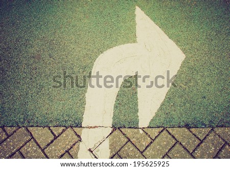 Vintage retro looking Arrow sign showing street road driving direction