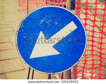 Vintage retro looking Arrow sign showing street road driving direction