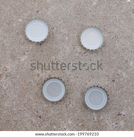 Beer bottle caps over concrete floor