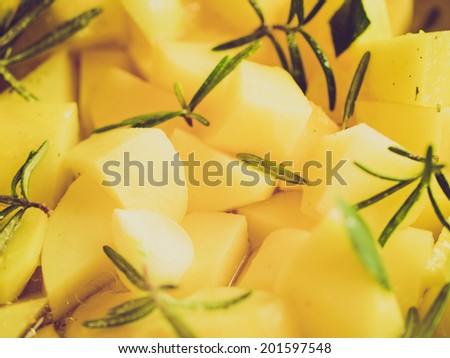 Vintage retro looking Potatoes with rosemary vegetarian food background