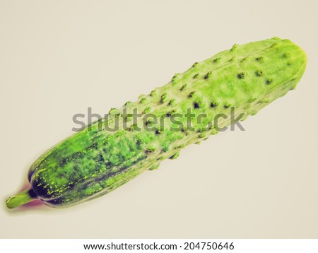 Vintage retro looking English cucumber vegetable isolated over a white background