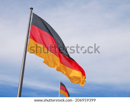 The national German flag of Germany over blue sky