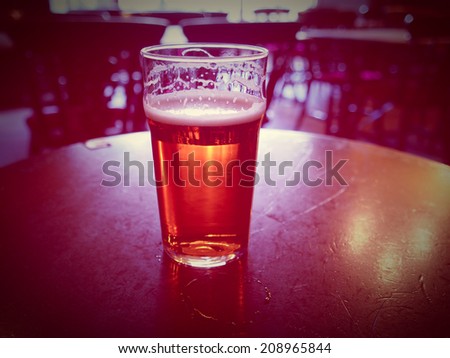 Vintage looking pint of English bitter ale in a pub