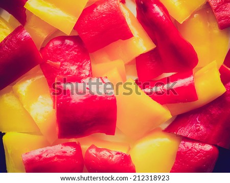 Vintage retro looking Red and yellow peppers useful as a food background