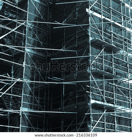 Temporary scaffold for construction works at building site - cool cyanotype