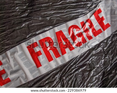 Fragile warning sign label tag on a packet parcel for shipping