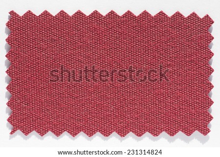 Red fabric swatch cut with pinking shears zig zag scissors