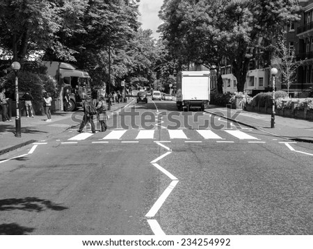 LONDON, ENGLAND, UK - JUNE 18: People crossing the Abbey Road zebra crossing made famous by the 1969 Beatles album cover on June 18, 2011 in London, England, UK