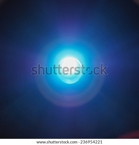 Bright blue led light over dark background