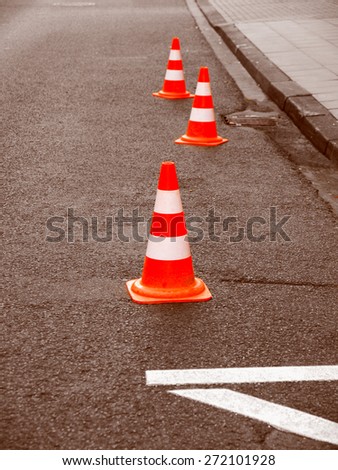 Vintage looking Range of traffic cones for road works - Selective colour over desaturated background