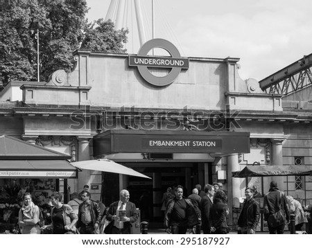 LONDON, UK - JUNE 09, 2015: Travellers at Embankment underground station in black and white
