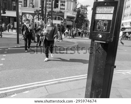 LONDON, UK - JUNE 10, 2015: Tourists in busy central London street in black and white