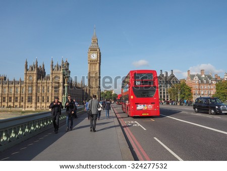 LONDON, UK - SEPTEMBER 28, 2015: Tourists on Westminster Bridge at the Houses of Parliament aka Westminster Palace