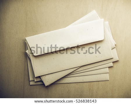 Vintage looking Letter envelopes for mail postage on wooden table