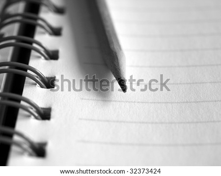 Blank notebook page with pencil on top
