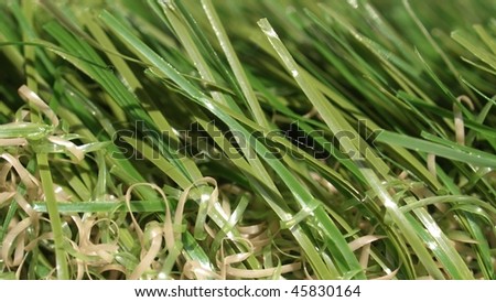 Detail of green grass artificial lawn meadow, useful as a background - (16:9 ratio)