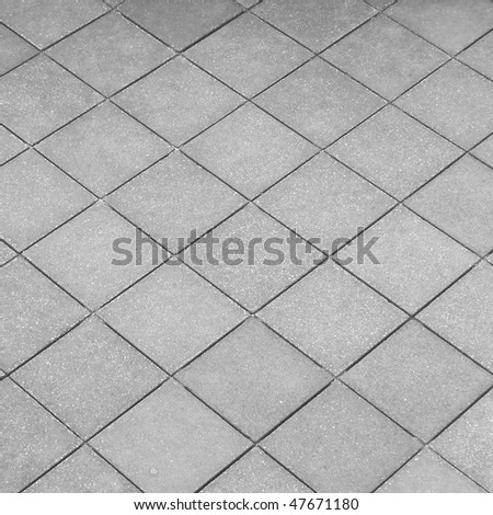 Raw concrete tiled pavement useful as a background