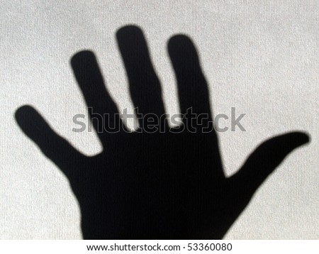 A dark black hand shadow symbolizing fear