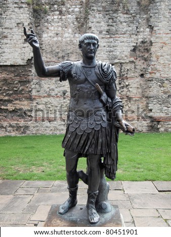 Ancient Roman monument statue of the Emperor Trajan in front of wall, London England UK United Kingdom archeology Rome