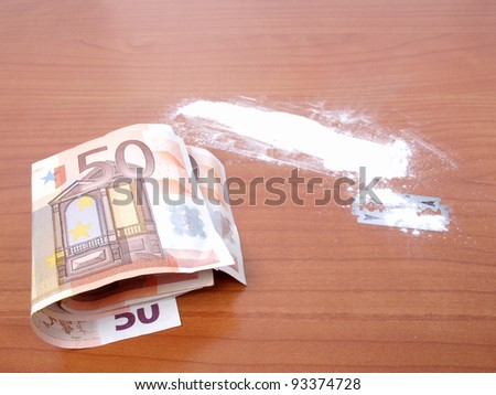 Cocaine drug with money and razor blade - Note: simulated with wheat flour, no real drugs used