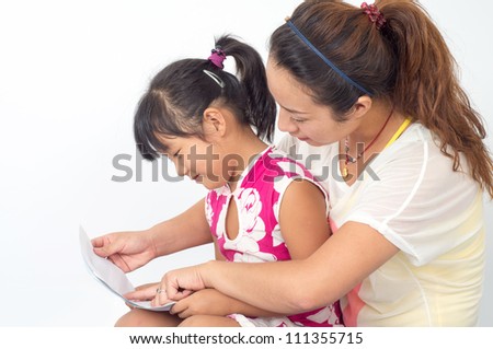 Pretty  mother and daughter  with a book