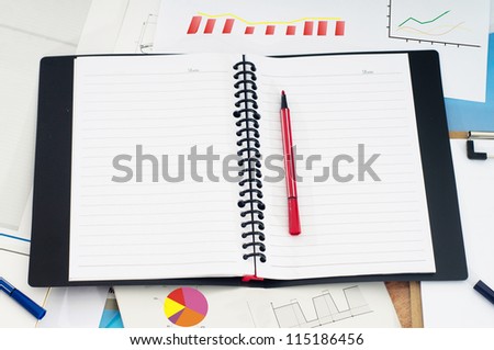 notebook and business accessories on a background of diagrams.