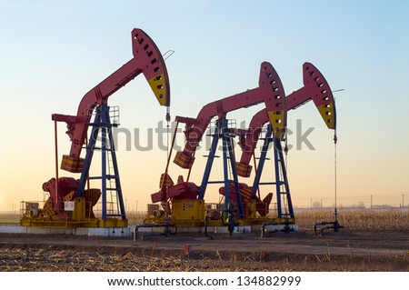 Work of oil pump jack on a oil field. Oil and gas industry.