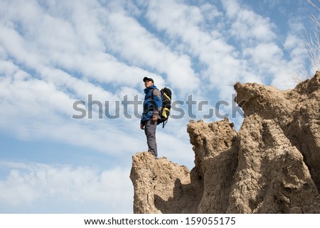Hiker standing on a cliff overlooking. Asian Youth