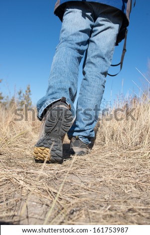 Man walking or running on trail in nature outdoors, sport shoes and exercising on footpath
