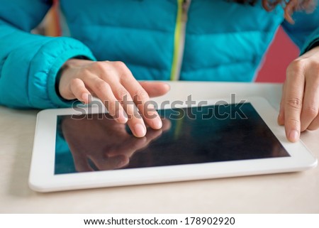 Woman finger pointing to the screen of a tablet-pc