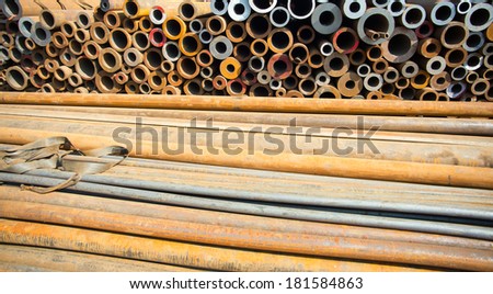 Rusty steel pipes stacked in outdoor sales