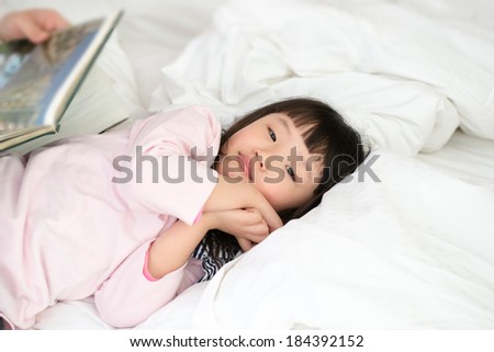 Mom With Children Reading Story in bed