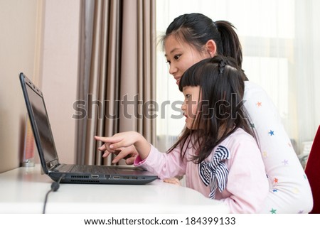 Young mother With Children use the notebook PC Indoors