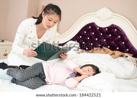 Mom With Children Reading Story in bed