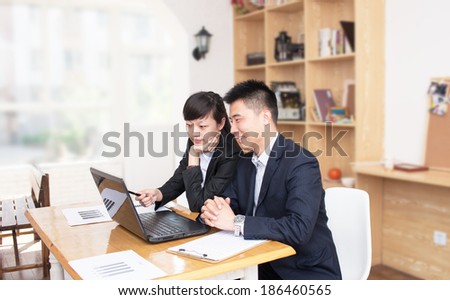 Two business people Having Meeting Around Table In Modern Office