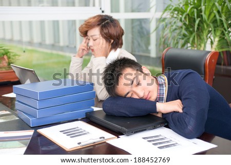 Two depressed business people, sleeping at your desk