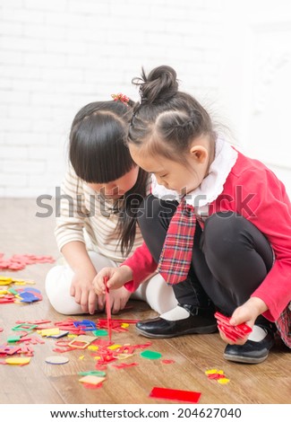 Two little girls play games in the indoor floor