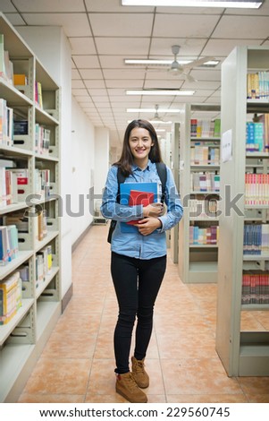 Portrait of a beautiful student in a library