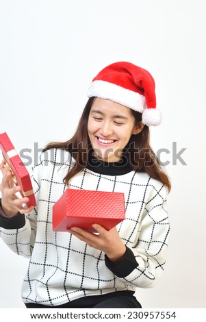 Girl showing off her Christmas gift. Happy woman with Christmas hats