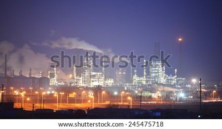 Oil and gas industry refinery factory petrochemical plant lit up at night