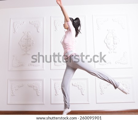 Grace young girl jumping exercises in Studio