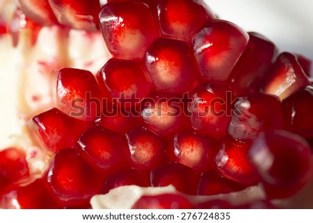closeup of peeling pomegranate red fruit.