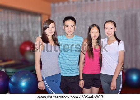Four young people at the gym, dynamic fitness team.