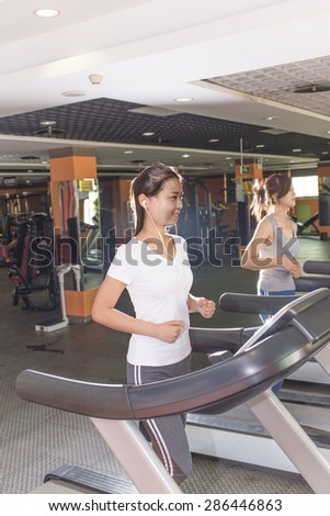 Woman running in a fitness club.