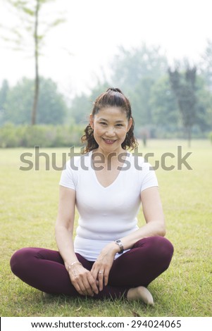 Older woman exercise fitness. Lawn in the Park of rest