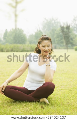 Older woman exercise fitness. Lawn in the Park of rest