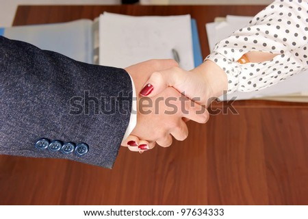 Shake hands with a man and a woman.