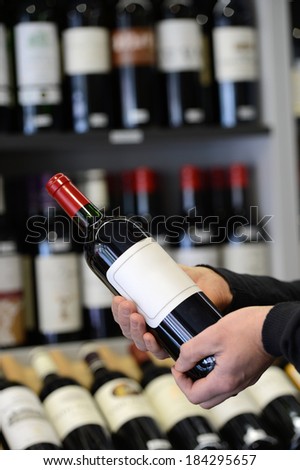 Choose and buy a bottle of wine in a specialty store
