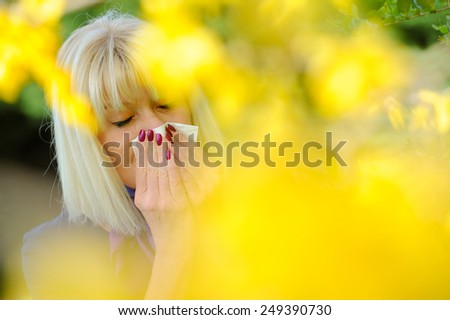 Senior woman blowing her nose outdoor